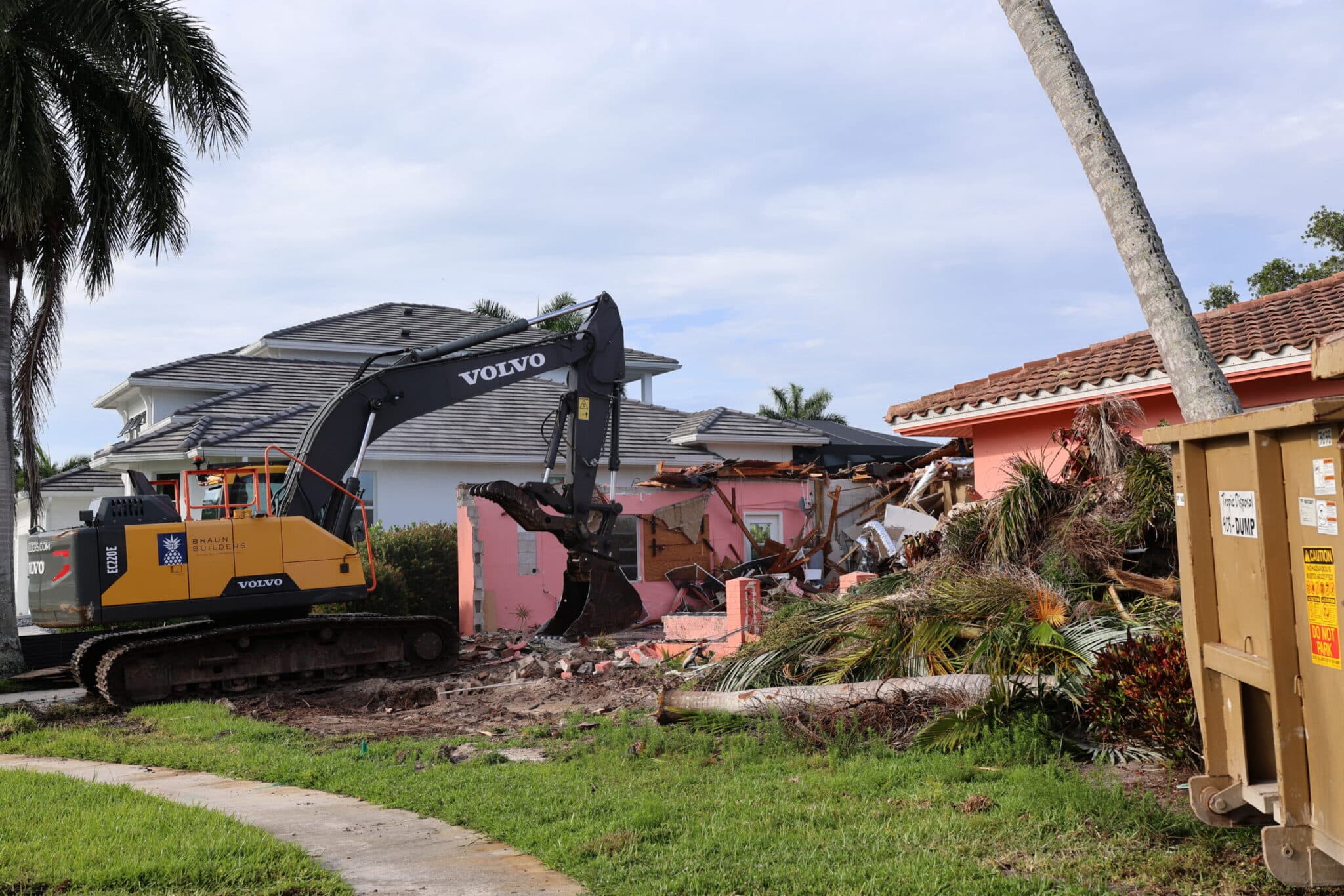 Residential demolition project with excavator and debris removal